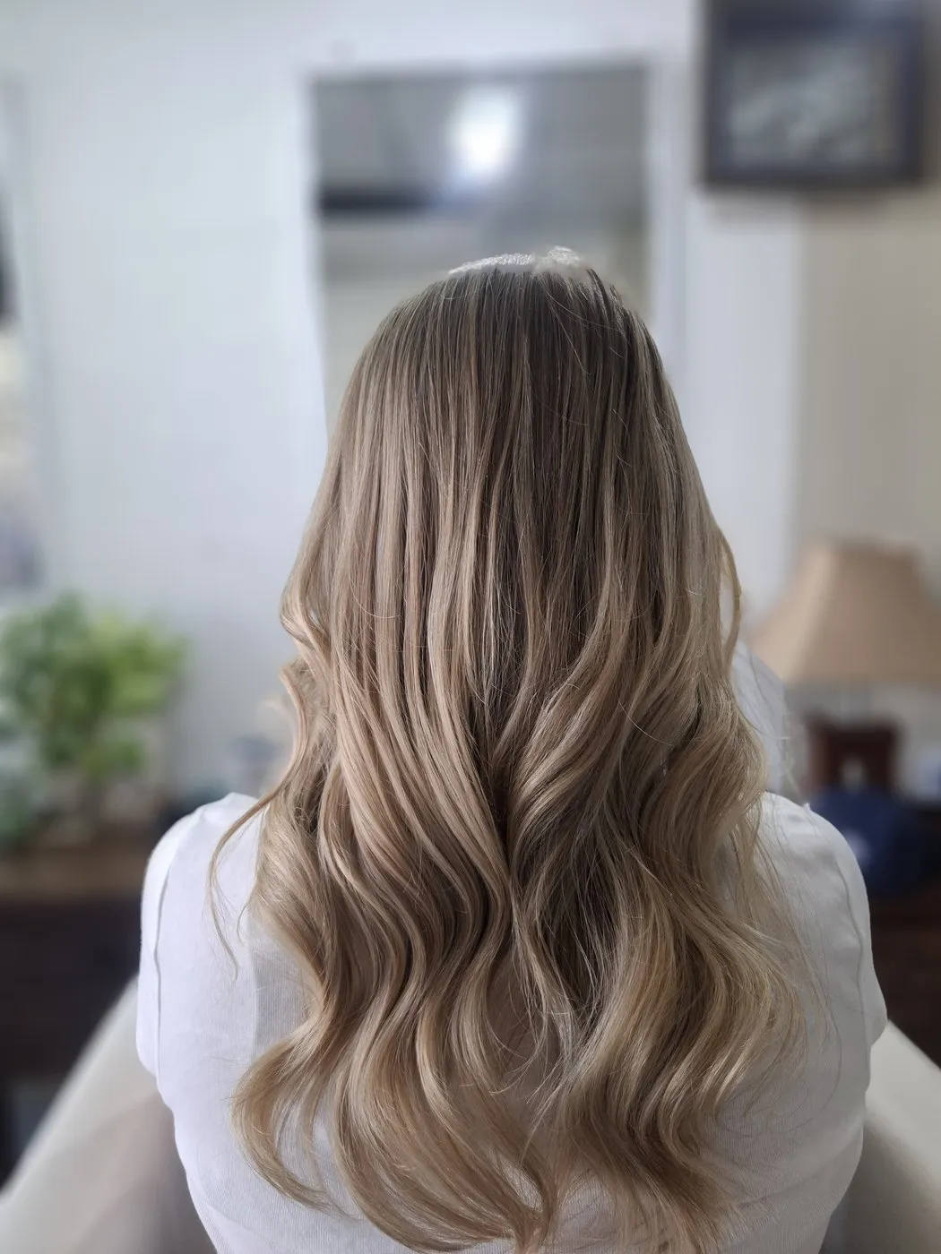 Blonde hair blow dried into waves, seen from behind