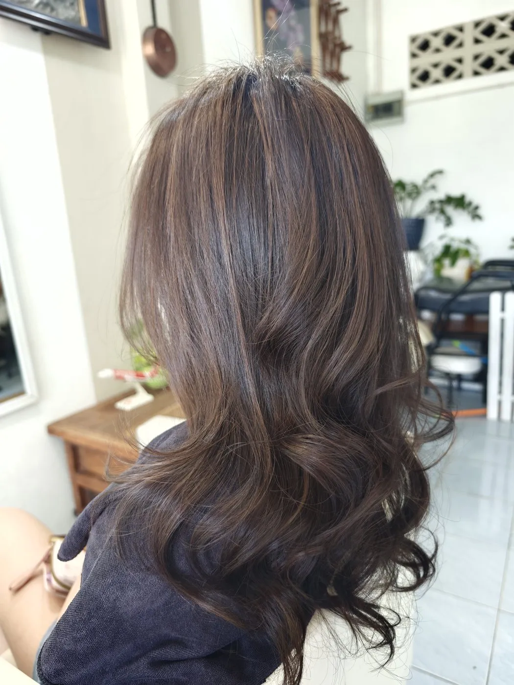 Long dark brown hair with soft waves, seen from behind