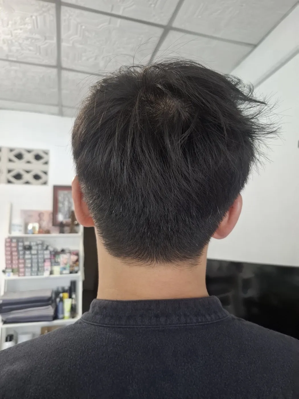 Short men’s cut with a textured top, seen from behind