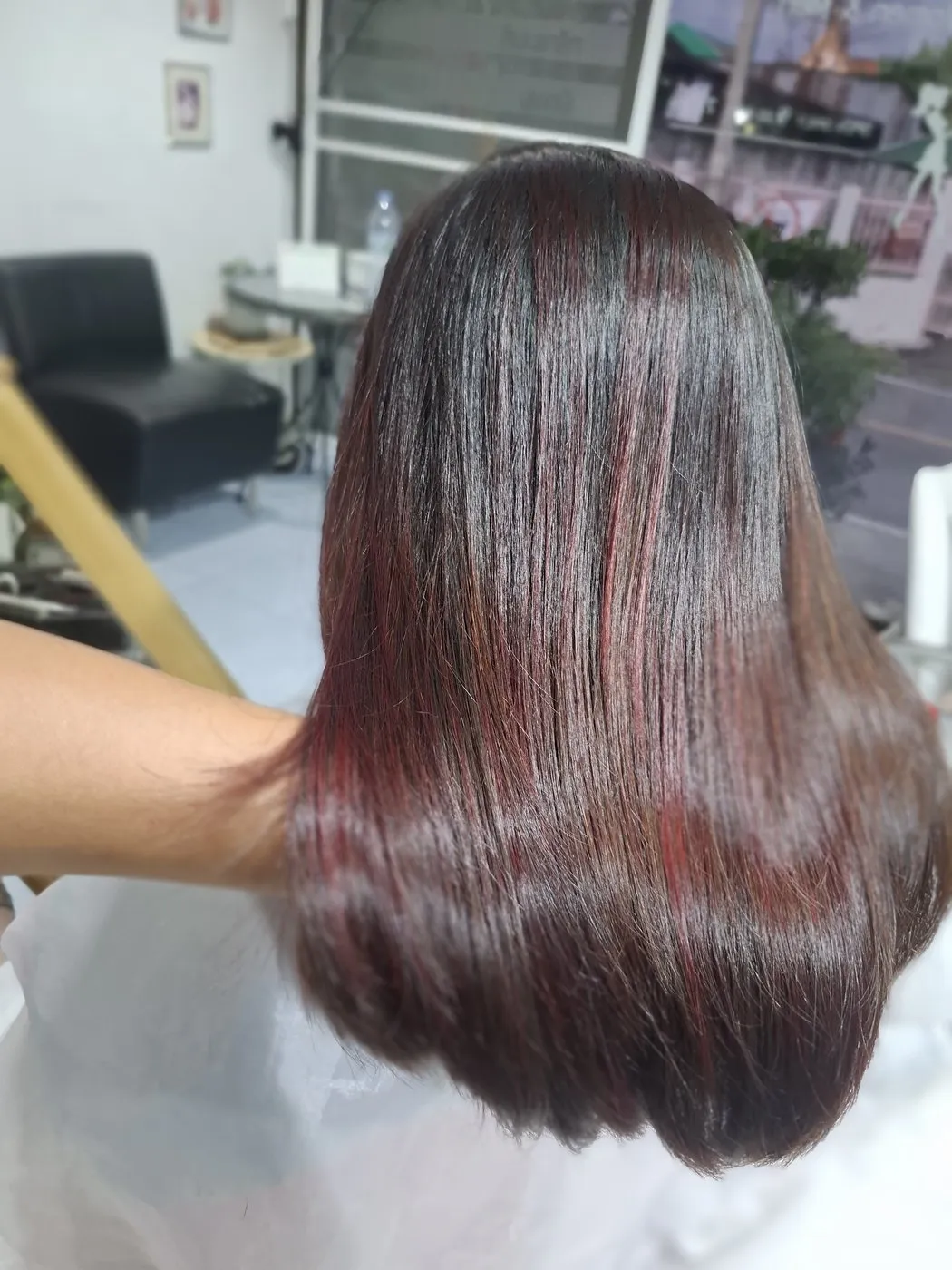 Glossy hair with red tones, seen from behind